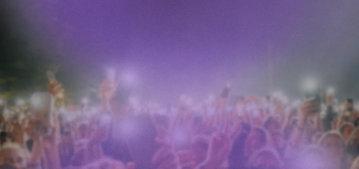 A woman on stage singing to the crowd